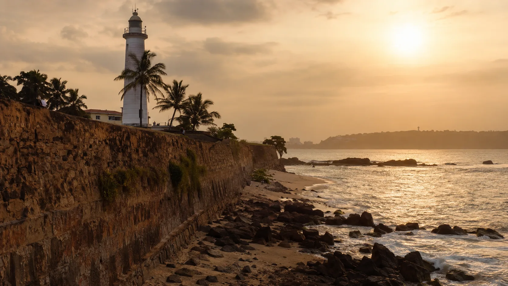 Galle Fort ramparts and lighthouse in warm evening light