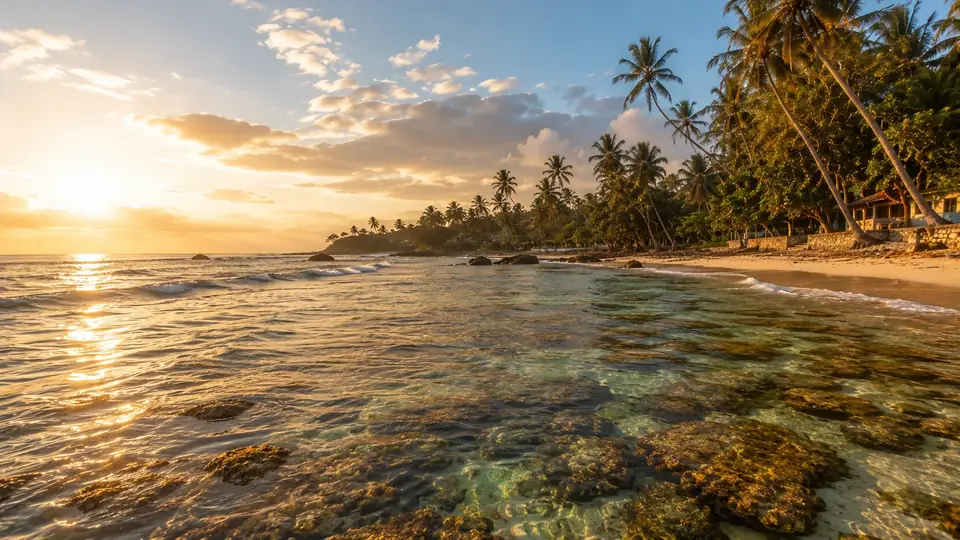 Hikkaduwa's reef shallows at golden hour with clear water over coral shapes
